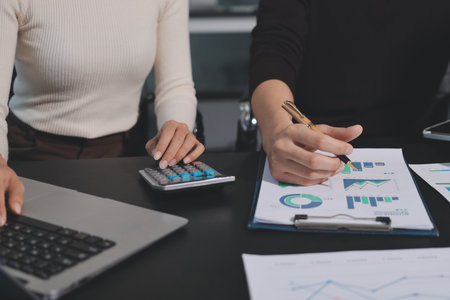 Accounting company provide finance and taxation planning for profitable cash flow, Auditor and accountant team working in office, analyze financial data and accounting record with calculator.Insightの写真素材