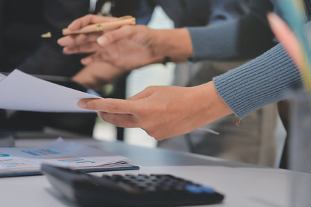 Accounting company provide finance and taxation planning for profitable cash flow, Auditor and accountant team working in office, analyze financial data and accounting record with calculator.Insightの写真素材