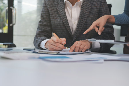 Accounting company provide finance and taxation planning for profitable cash flow, Auditor and accountant team working in office, analyze financial data and accounting record with calculator.Insightの写真素材