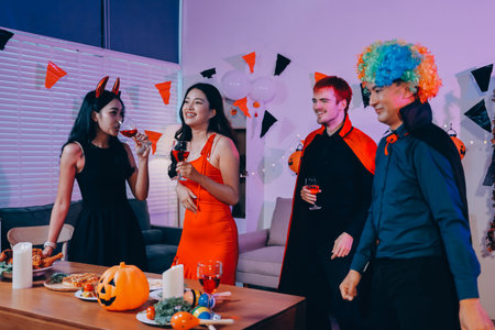Joyful office Halloween party with coworkers in costumes, celebrating with drinks and laughter, fostering teamwork and festive spiritの写真素材