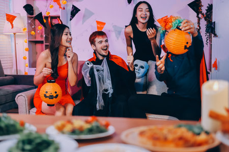Joyful office Halloween party with coworkers in costumes, celebrating with drinks and laughter, fostering teamwork and festive spiritの写真素材
