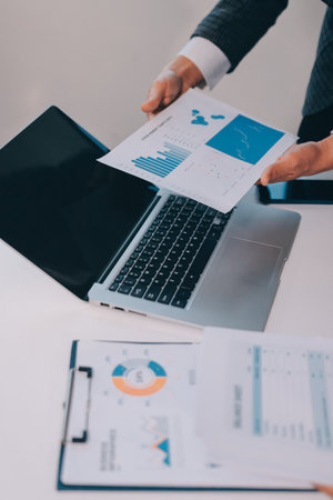 Accounting company provide finance and taxation planning for profitable cash flow, Auditor and accountant team working in office, analyze financial data and accounting record with calculator.Insightの写真素材