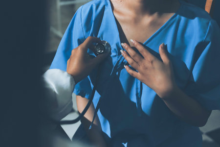 healthy concept; Doctor checking patient's heart with stethoscope at a hospital