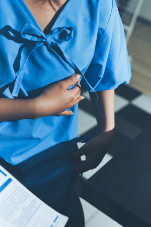 healthy concept; Doctor checking patient's heart with stethoscope at a hospitalの写真素材