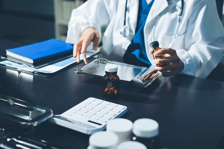 Female doctor holding a medicine bottle is checking the quality of medicine for any side effects the...
