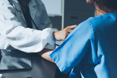 healthy concept; Doctor checking patient's heart with stethoscope at a hospital