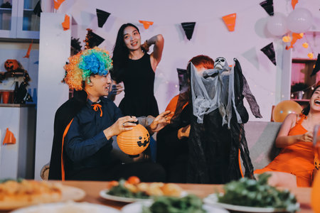 Joyful Halloween party with coworkers in costumes, celebrating with drinks and laughter, fostering teamwork and festive spiritの写真素材