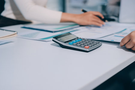 Accounting company provide finance and taxation planning for profitable cash flow, Auditor and accountant team working in office, analyze financial data and accounting record with calculator.Insightの写真素材