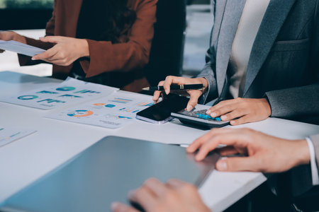 Accounting company provide finance and taxation planning for profitable cash flow, Auditor and accountant team working in office, analyze financial data and accounting record with calculator.Insightの写真素材