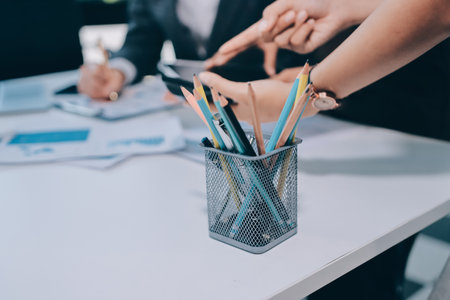 Accounting company provide finance and taxation planning for profitable cash flow, Auditor and accountant team working in office, analyze financial data and accounting record with calculator.の写真素材