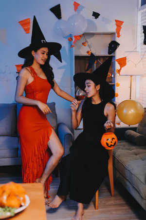 Joyful Halloween party with friends in costumes, celebrating with drinks and laughter, fostering...