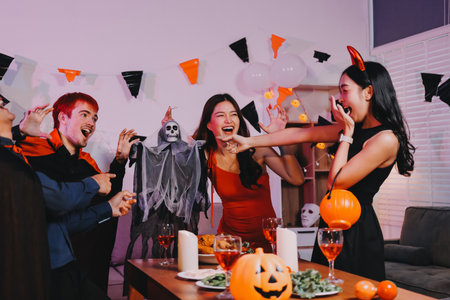 Joyful Halloween party with coworkers in costumes, celebrating with drinks and laughter, fostering teamwork and festive spiritの写真素材