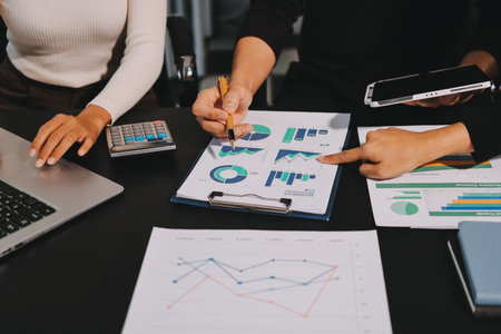 Accounting company provide finance and taxation planning for profitable cash flow, Auditor and accountant team working in office, analyze financial data and accounting record with calculator.Insightの写真素材