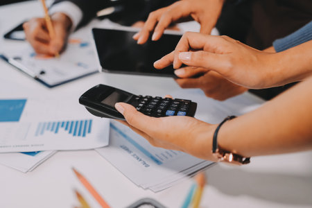 Accounting company provide finance and taxation planning for profitable cash flow, Auditor and accountant team working in office, analyze financial data and accounting record with calculator.Insightの写真素材