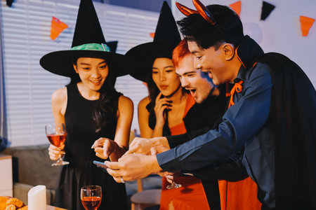 Joyful office Halloween party with coworkers in costumes, celebrating with drinks and laughter, fostering teamwork and festive spiritの写真素材