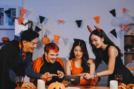 Joyful office Halloween party with coworkers in costumes, celebrating with drinks and laughter, fostering teamwork and festive spiritの写真素材