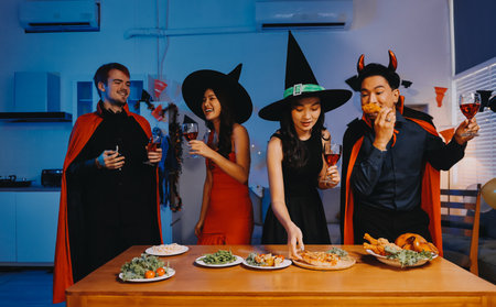 Joyful Halloween party with coworkers in costumes, celebrating with drinks and laughter, fostering...