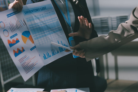 Close up high angle Asian businesswoman working with her coworker in meeting roomの写真素材