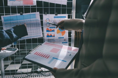 Close up high angle Asian businesswoman working with her coworker in meeting roomの写真素材