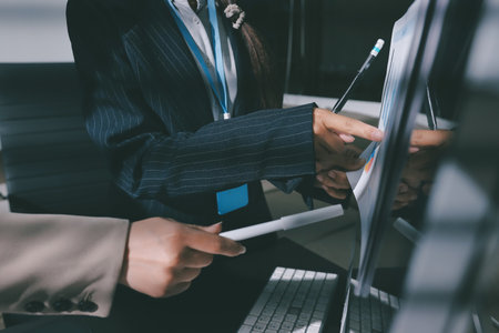 Close up high angle Asian businesswoman working with her coworker in meeting roomの写真素材