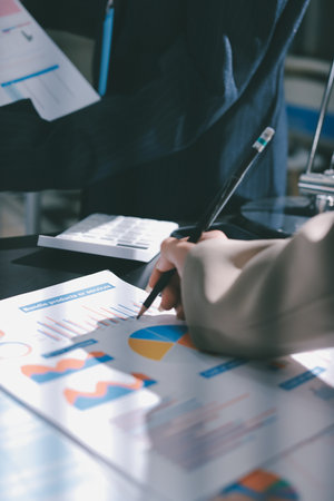 Close up high angle Asian businesswoman working with her coworker in meeting roomの写真素材
