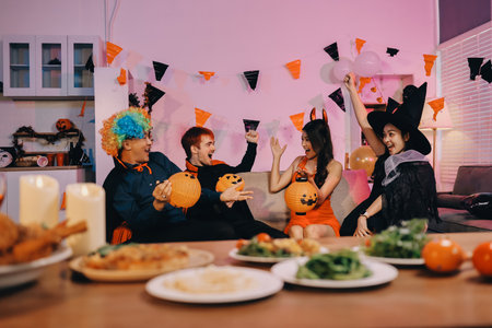 Joyful Halloween party with coworkers in costumes, celebrating with drinks and laughter, fostering teamwork and festive spiritの写真素材