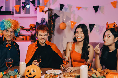 Joyful office Halloween party with coworkers in costumes, celebrating with drinks and laughter, fostering teamwork and festive spiritの写真素材