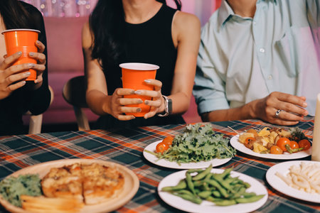 Diversity, dinner and group of people toast celebration together at party. Friends, happy and...
