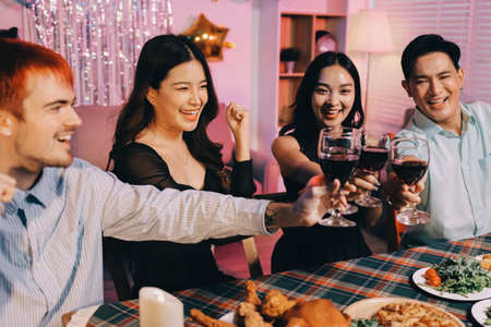 Diversity, dinner and group of people toast celebration together at party. Friends, happy and celebrate with food, wine and friendship for love, support and cheers champagne at business functionの写真素材