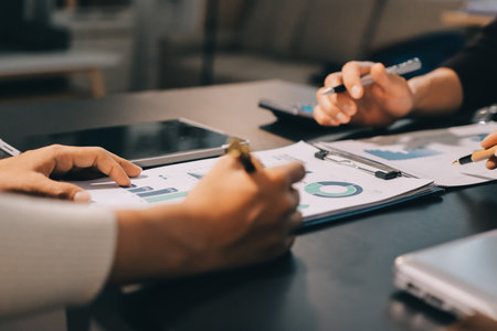 Accounting company provide finance and taxation planning for profitable cash flow, Auditor and accountant team working in office, analyze financial data and accounting record with calculator.Insightの写真素材