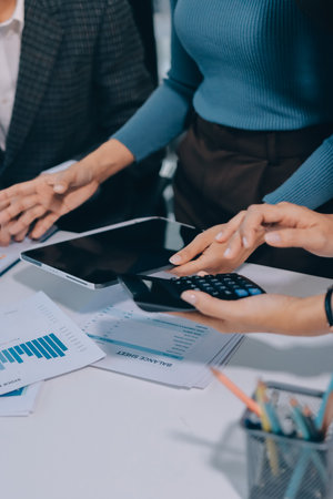 Accounting company provide finance and taxation planning for profitable cash flow, Auditor and accountant team working in office, analyze financial data and accounting record with calculator.Insightの写真素材