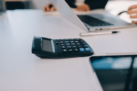 Accounting company provide finance and taxation planning for profitable cash flow, Auditor and accountant team working in office, analyze financial data and accounting record with calculator.の写真素材