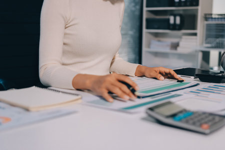 Accounting company provide finance and taxation planning for profitable cash flow, Auditor and accountant team working in office, analyze financial data and accounting record with calculator.Insightの写真素材