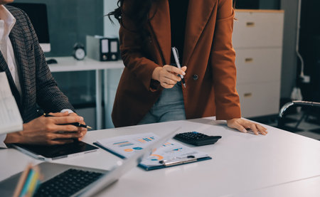 Accounting company provide finance and taxation planning for profitable cash flow, Auditor and accountant team working in office, analyze financial data and accounting record with calculator.Insightの写真素材