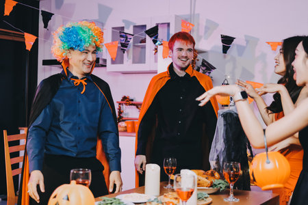 Joyful Halloween party with coworkers in costumes, celebrating with drinks and laughter, fostering teamwork and festive spiritの写真素材