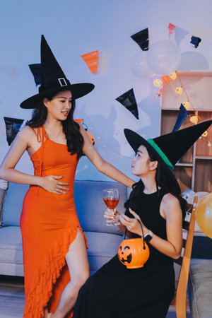 Joyful Halloween party with coworkers in costumes, celebrating with drinks and laughter, fostering teamwork and festive spiritの写真素材