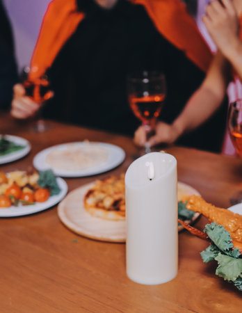 Joyful office Halloween party with coworkers in costumes, celebrating with drinks and laughter, fostering teamwork and festive spiritの写真素材