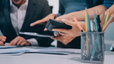 Accounting company provide finance and taxation planning for profitable cash flow, Auditor and accountant team working in office, analyze financial data and accounting record with calculator.Insightの写真素材