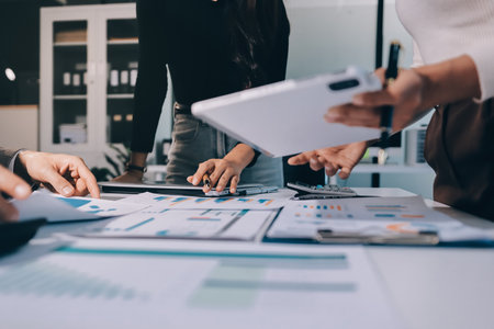 Accounting company provide finance and taxation planning for profitable cash flow, Auditor and accountant team working in office, analyze financial data and accounting record with calculator.Insightの写真素材