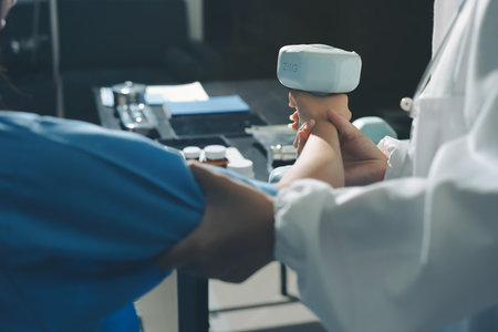 Physical therapist assisting a woman with dumbbell exerciseの写真素材