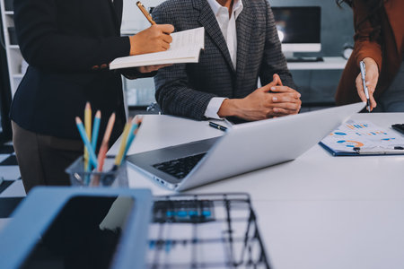 Accounting company provide finance and taxation planning for profitable cash flow, Auditor and accountant team working in office, analyze financial data and accounting record with calculator.Insightの写真素材