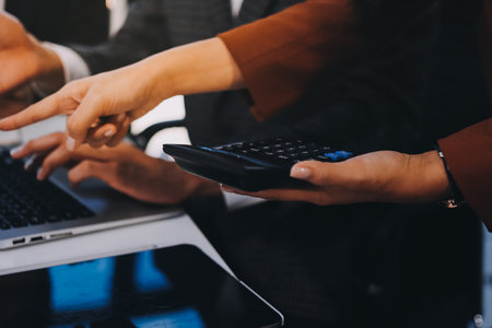 Accounting company provide finance and taxation planning for profitable cash flow, Auditor and accountant team working in office, analyze financial data and accounting record with calculator.Insightの写真素材