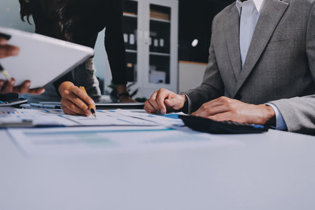Accounting company provide finance and taxation planning for profitable cash flow, Auditor and accountant team working in office, analyze financial data and accounting record with calculator.Insightの写真素材