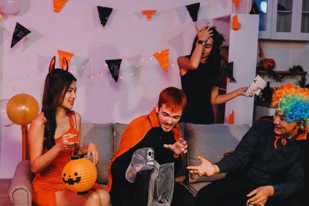 Joyful Halloween party with coworkers in costumes, celebrating with drinks and laughter, fostering...