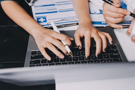 Group of doctors attending seminar in hospital lecture hall with senior physician giving medical presentation and professional training session on healthcare practicesの写真素材