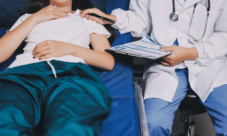 Compassionate Female Doctor Examining Senior Patient in Hospital Bed, Showing Empathy and Careの写真素材