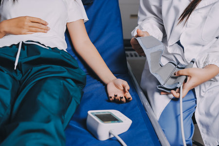 Nurse measuring blood pressure of elderly woman at table, closeup. Assisting senior generation