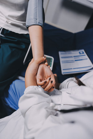 Nurse measuring blood pressure of elderly woman at table, closeup. Assisting senior generationの写真素材