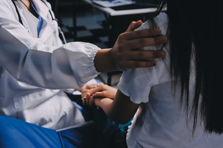 Doctor giving hope. Close up shot of young female physician leaning forward to smiling elderly lady patient holding her hand in palms. Woman caretaker in white coat supporting encouraging old personの写真素材