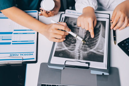 Group of doctors attending seminar in hospital lecture hall with senior physician giving medical presentation and professional training session on healthcare practicesの写真素材